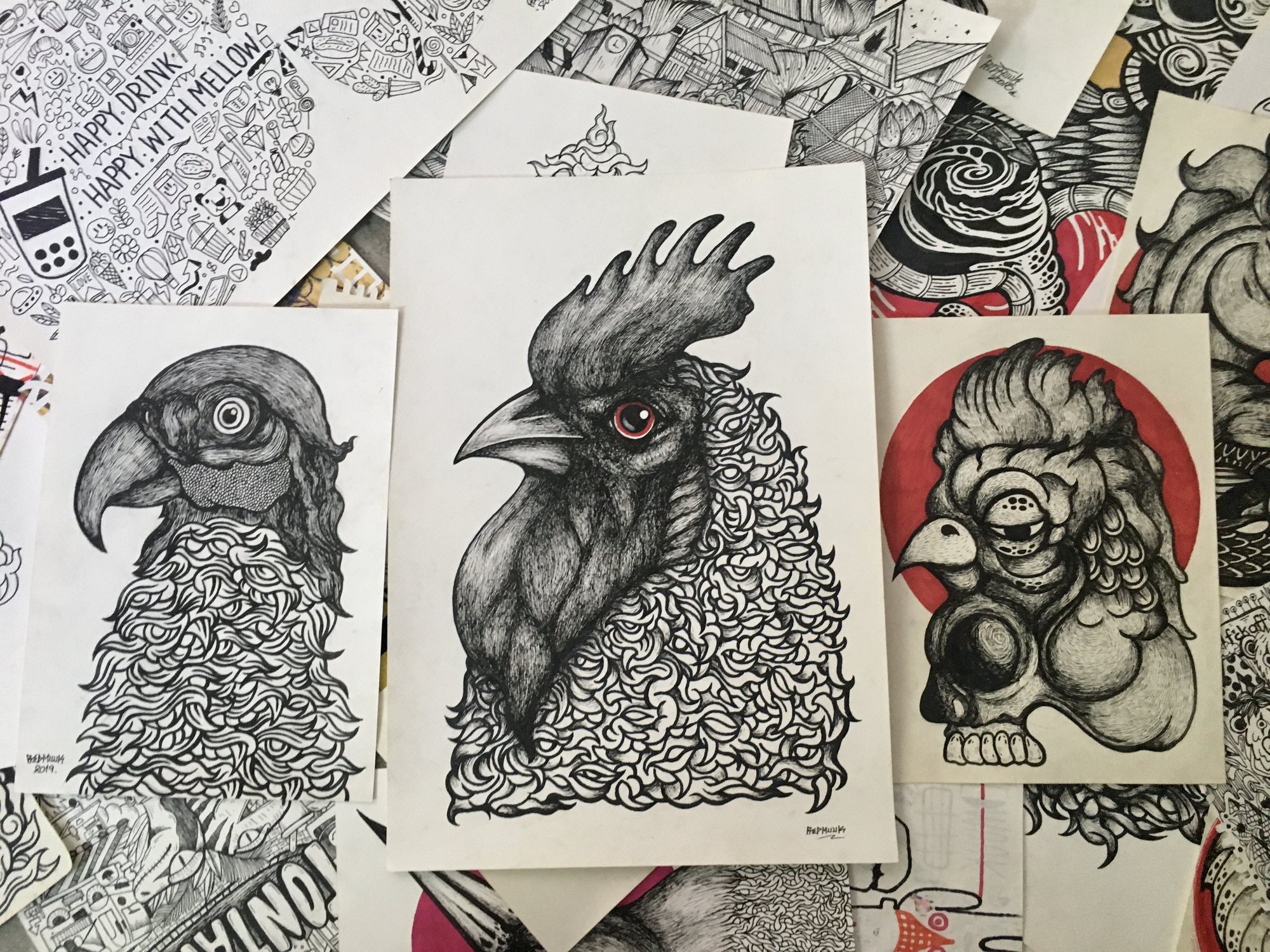 ภาพวาดหัวนกสามภาพบนกระดาษซ้อนกัน ไก่ตรงกลางมีตาสีแดง ภาพขวามีวงกลมสีแดงด้านหลัง รอบข้างมีภาพลายเส้นและตัวหนังสือ